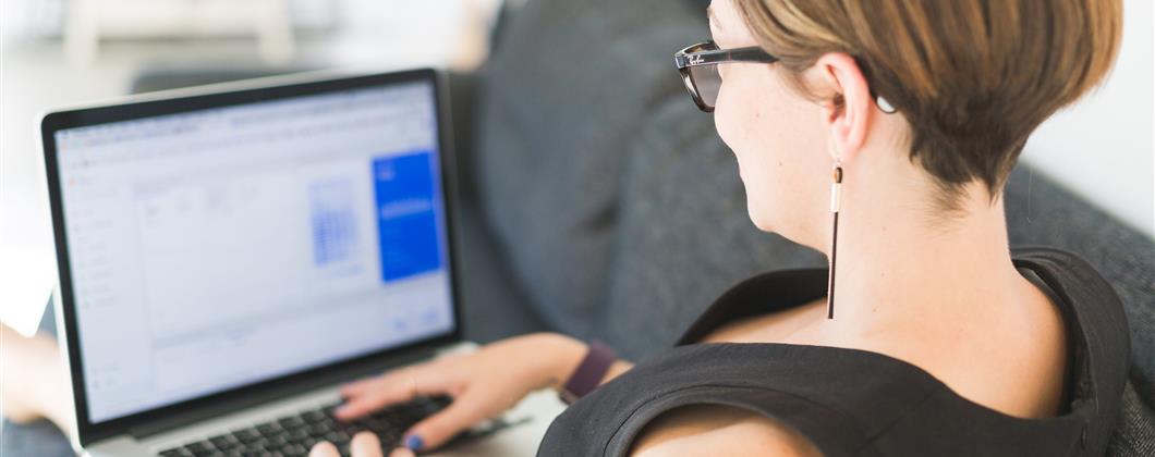 Woman Working On Office Sofa