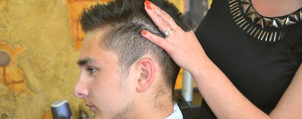 Customer getting a hair cut in a barbers covered by Commercial Insurance